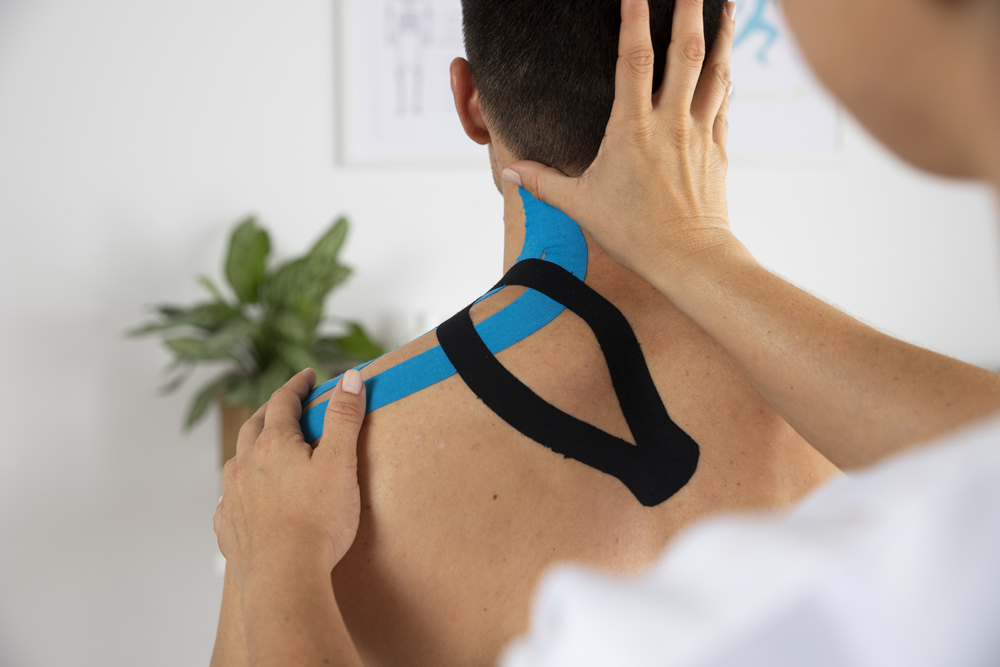 female-physiotherapist-applying-elastic-medical-bandage-male-patient (1)